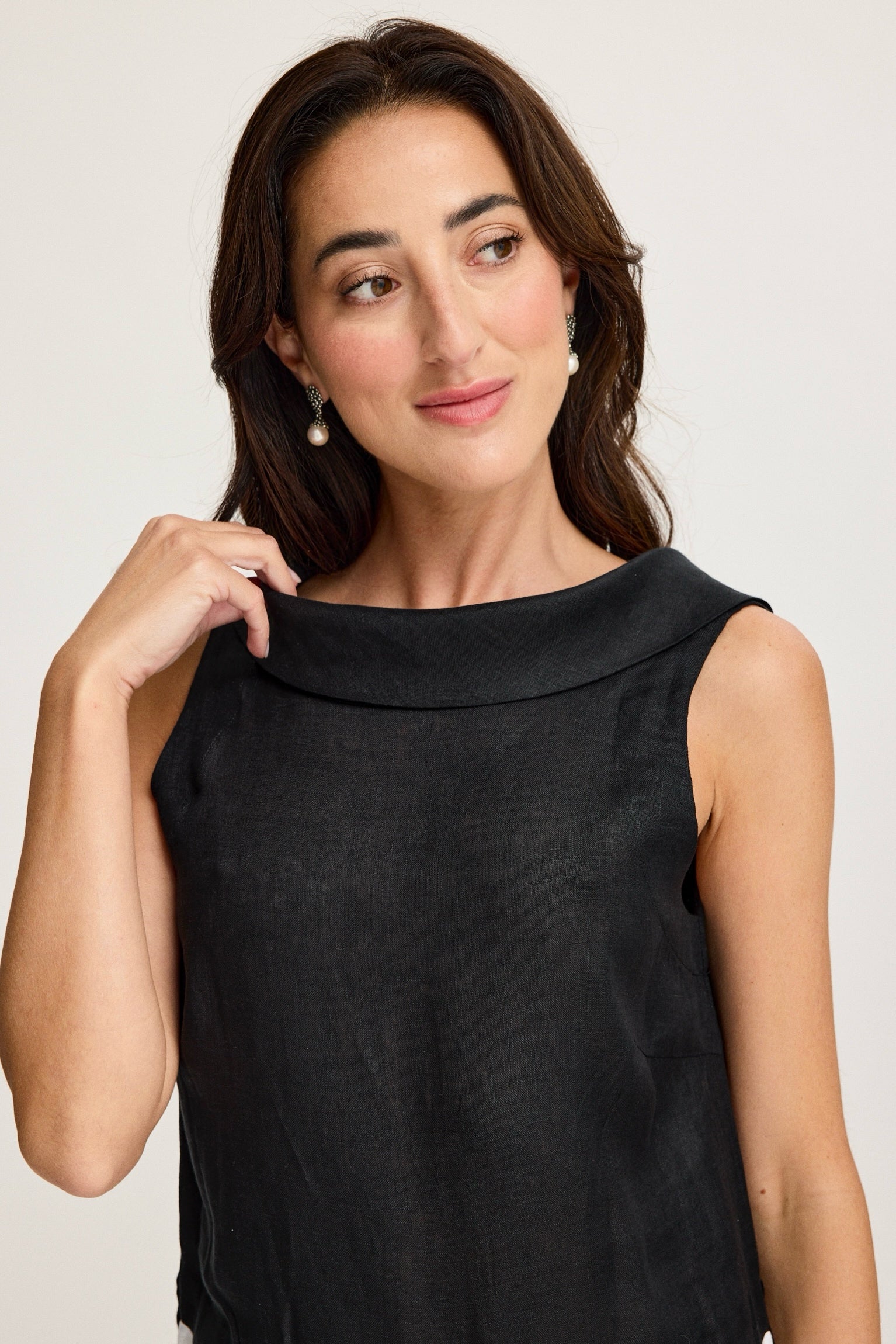 Woman wearing a black sleeveless top against a plain background Black & White
