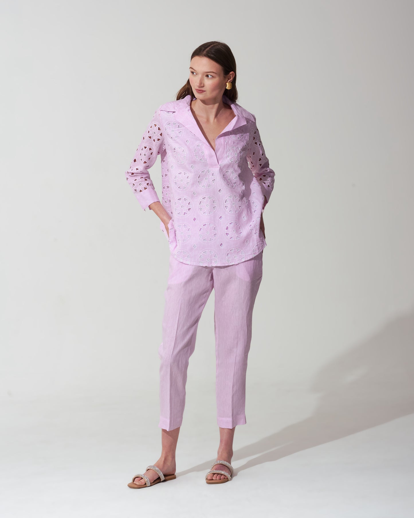 Woman wearing a Pastel Pink outfit with a matching top and pants on a background