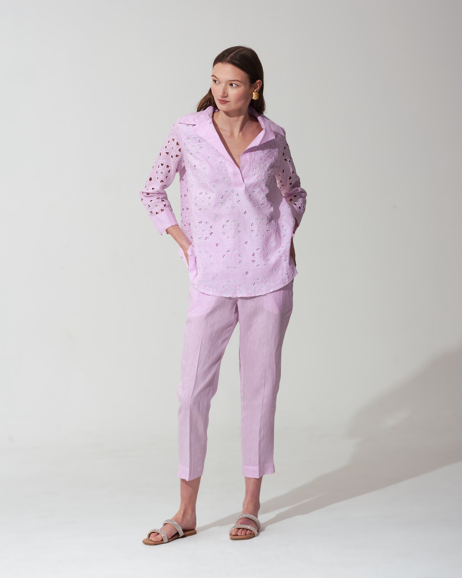 Woman wearing a Pastel Pink outfit with a matching top and pants on a background