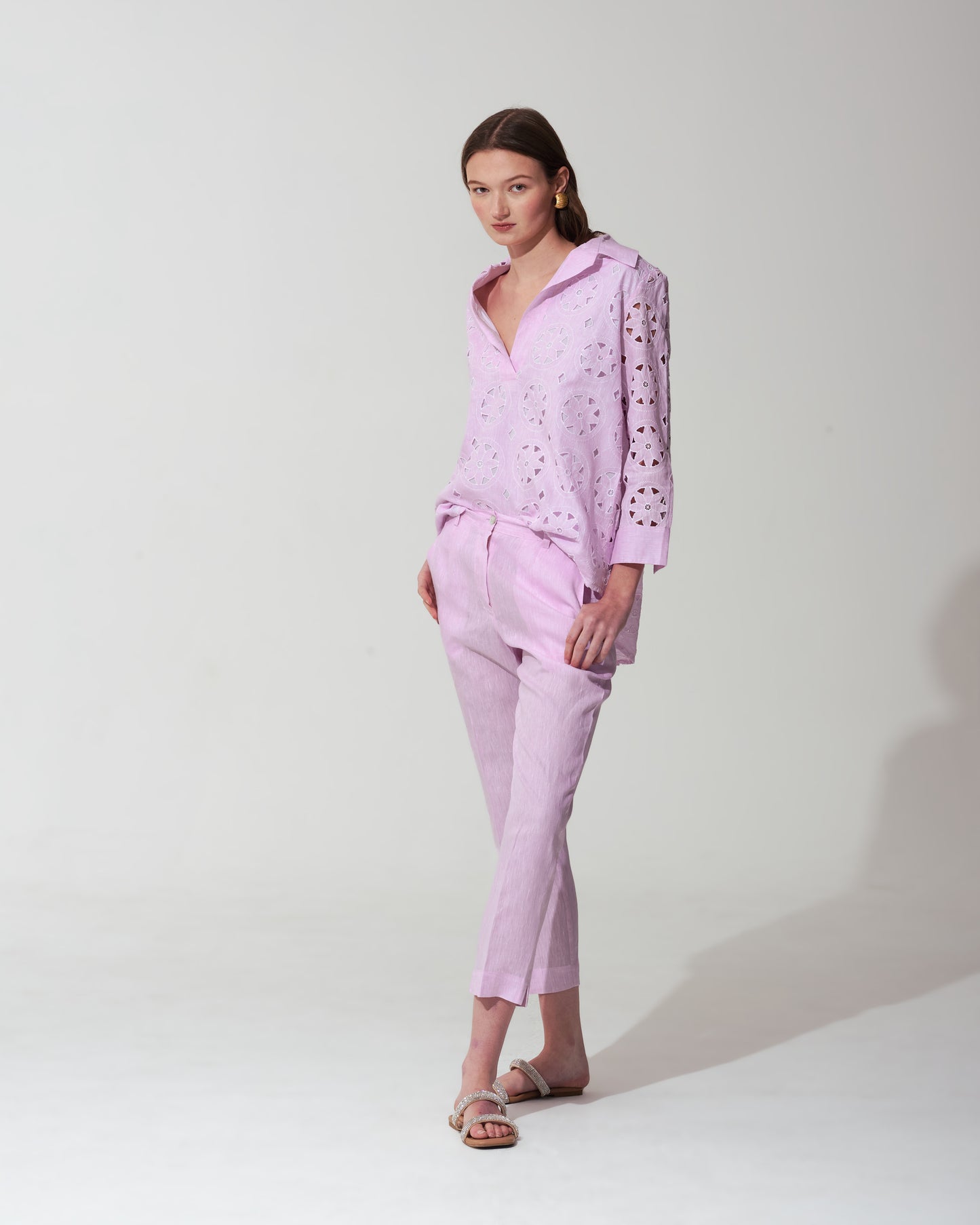 Woman wearing a pastel pink set on  background