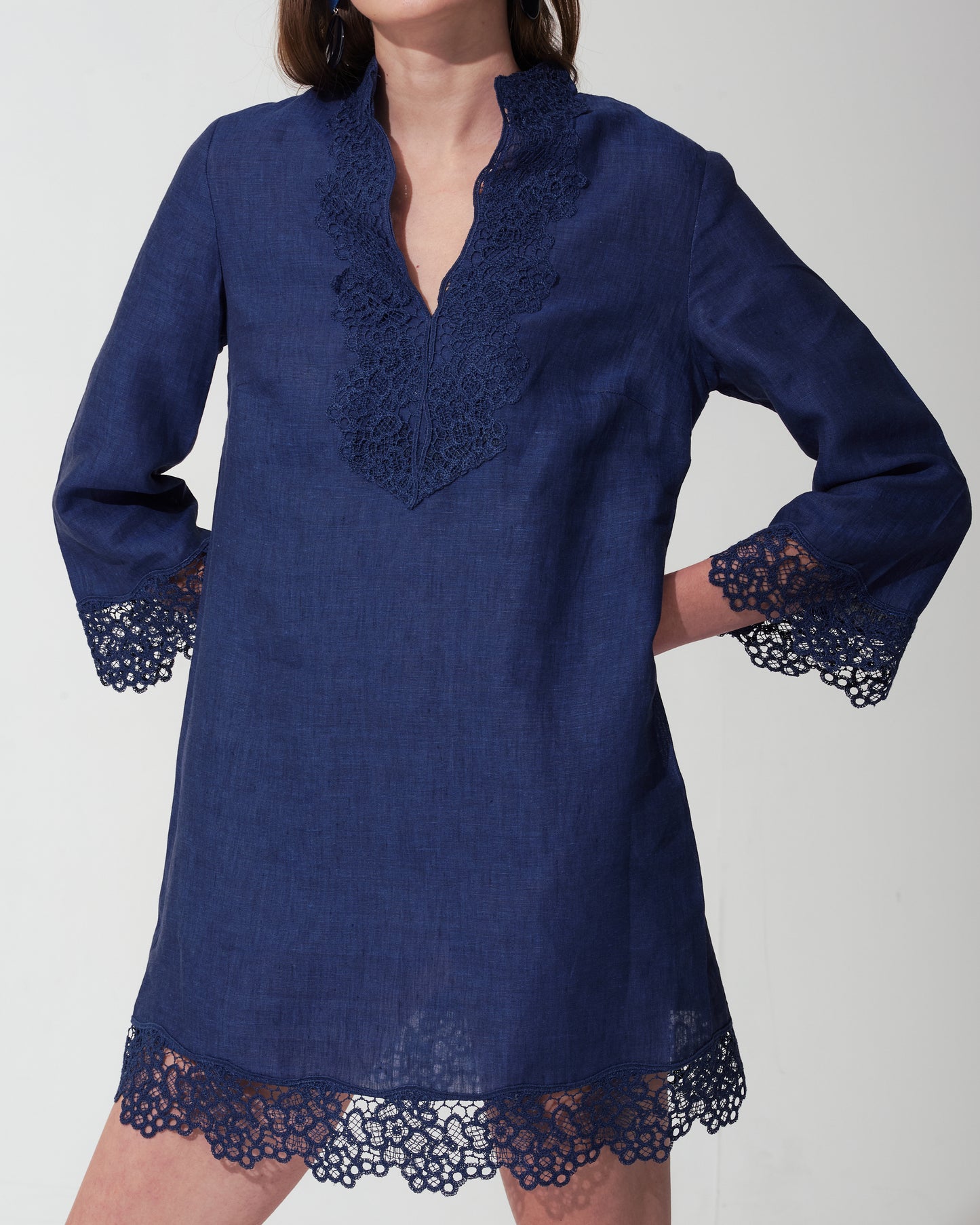 Blue Royal dress with lace details on a plain background